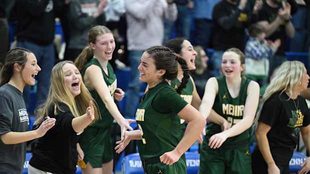 Medina's Olivia Klanac celebrates with teammates after being taken out of the game in a district final win over Archbishop Hoban on March 1, 2024.
